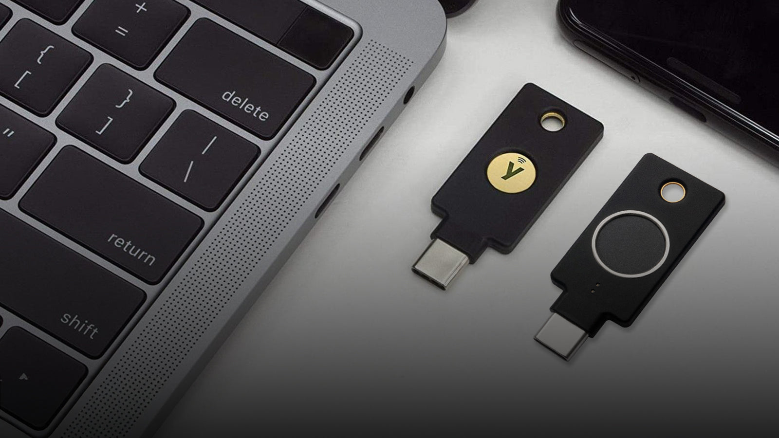 YubiKey Bio and YubiKey 5C NFC next to a laptop